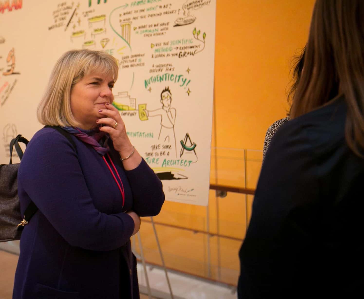 Dr. Deborah Streeter smiles while she listens to a student