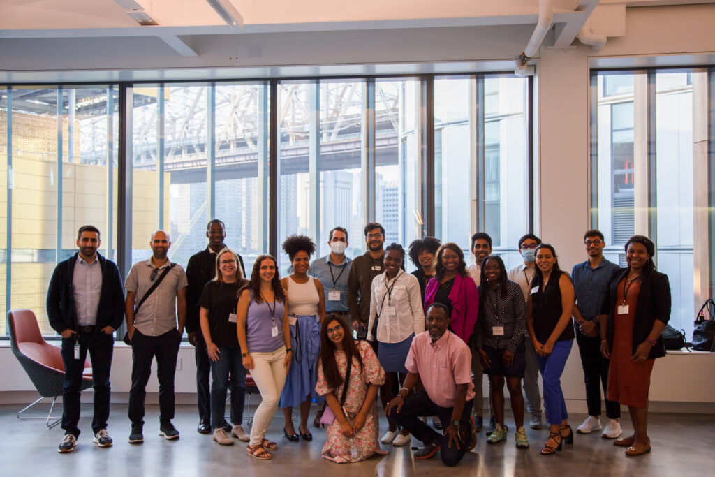 The GEM Fellows cohort poses in front of a large picture window.