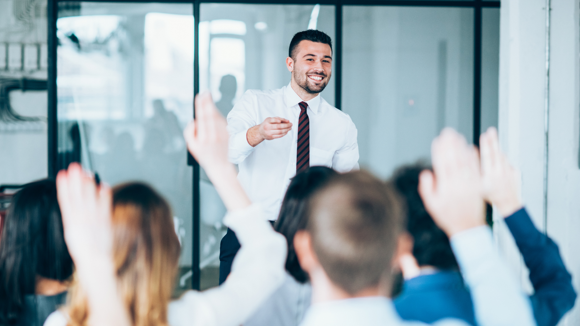 a man leads a room of people in a training