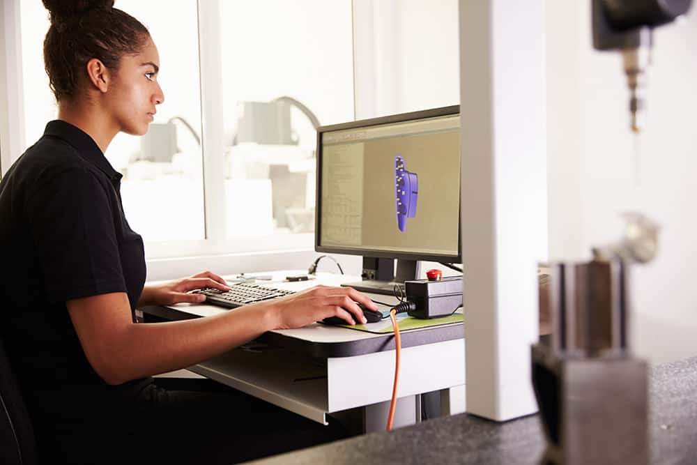 A female entrepreneur creates a CAD drawing on a computer