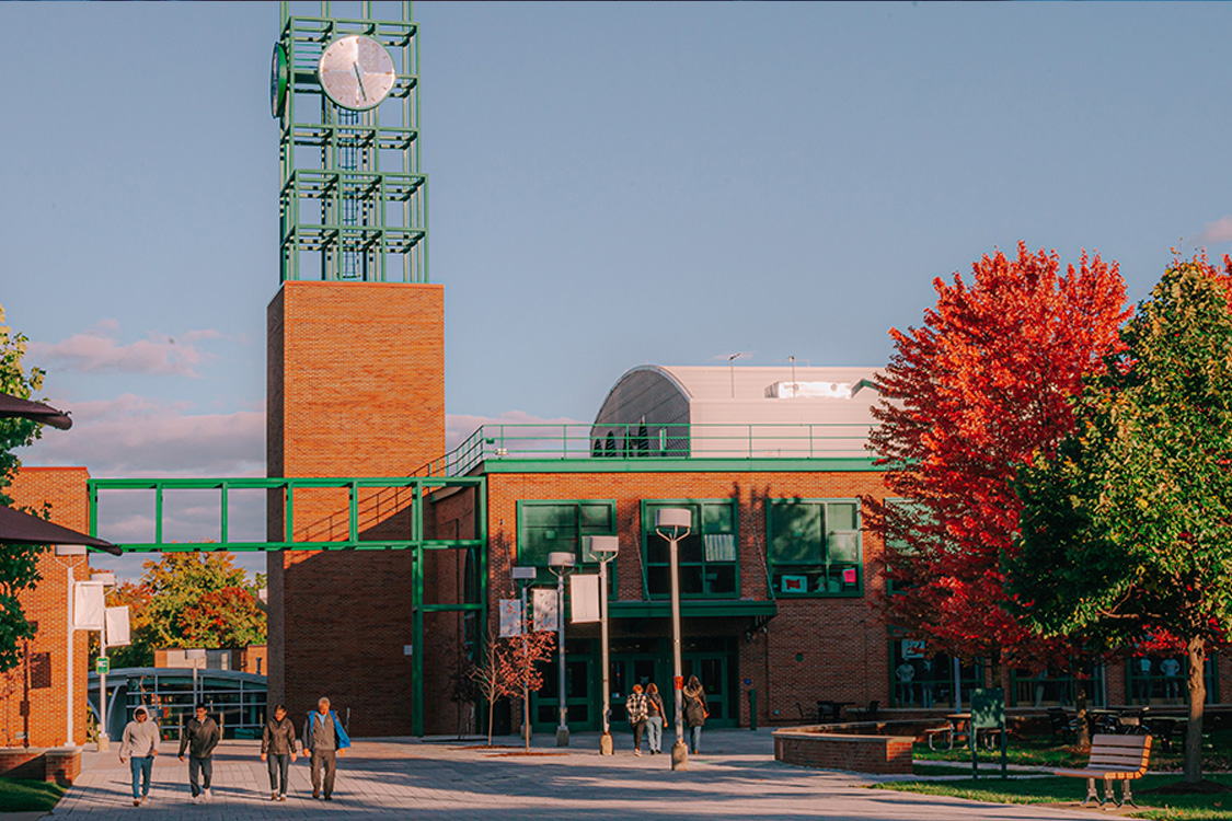 View of the clock tower on the Binghamton University campus on a sunny fall day