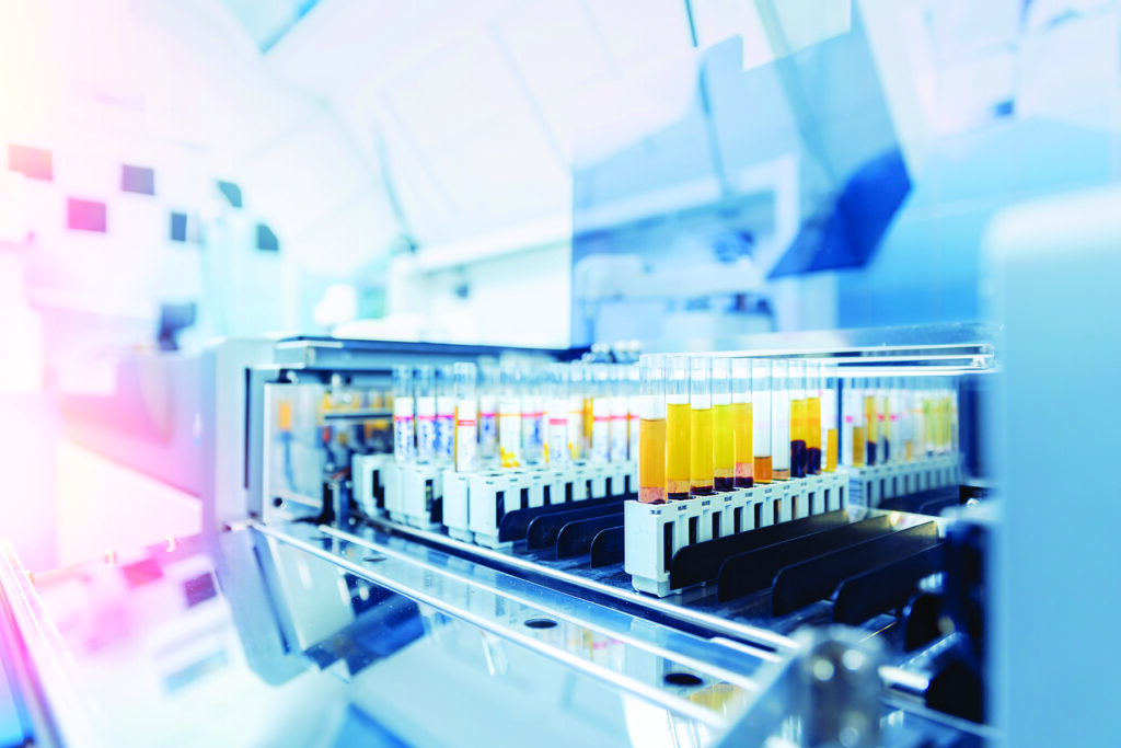 Scientist working with auto robotical machine for testing blood, modern laboratory medical equipment.
