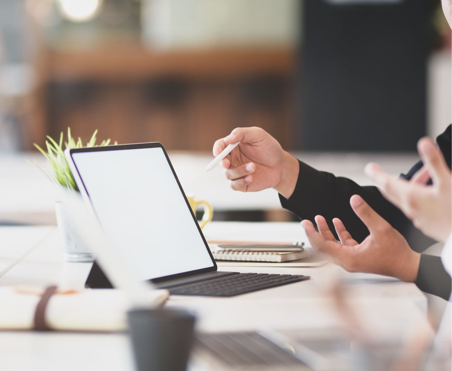 Hands gesturing to a laptop