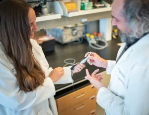 two dentists inspecting a dental drill